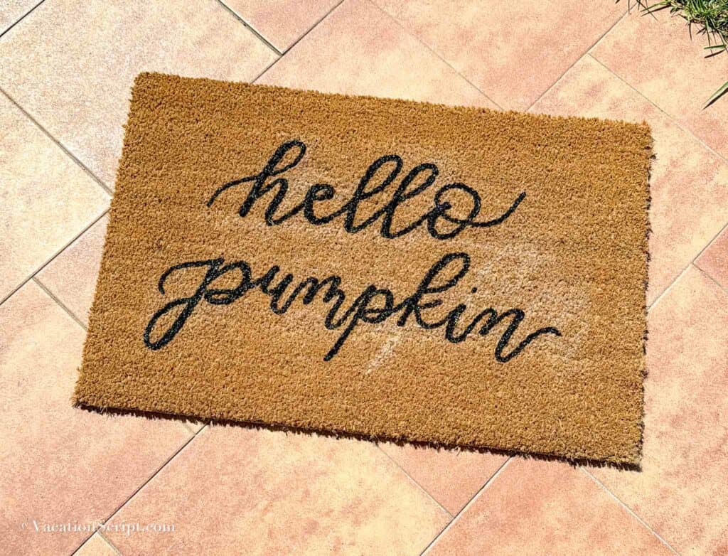 hello pumpkin hand lettered on a custom doormat
