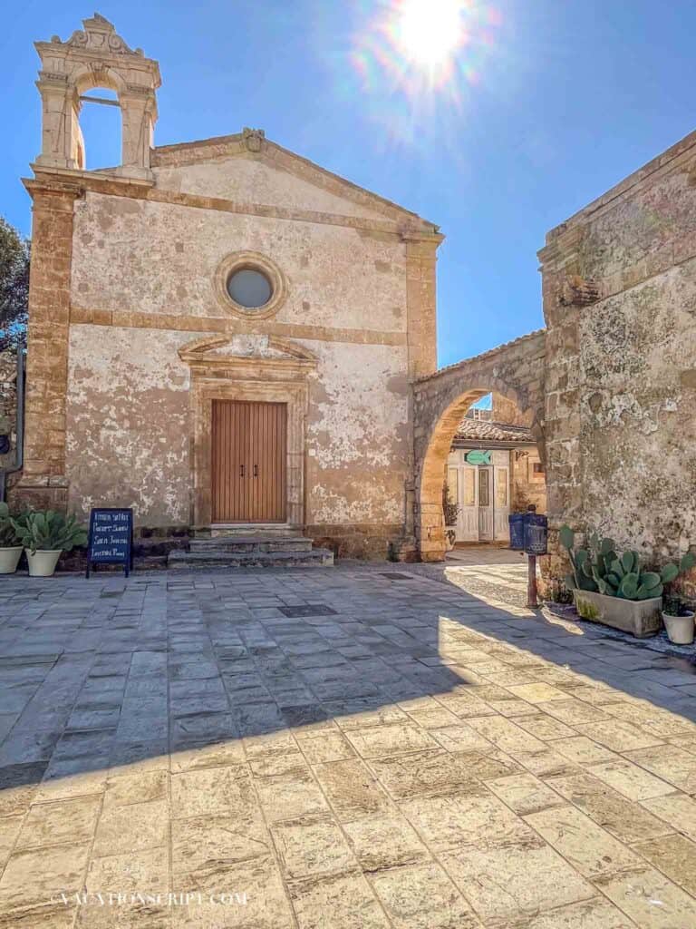 Sunlit stone facade of San Francesco di Paola Church in Marzememi, Sicily, near the sea