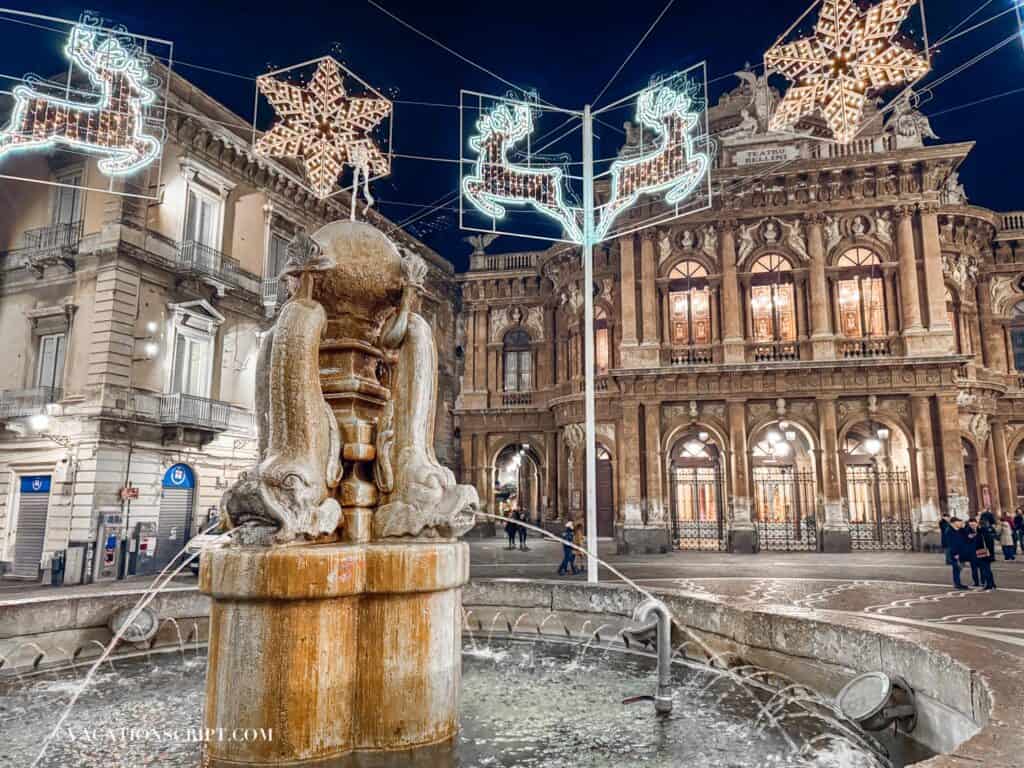 Teatro Massimo Bellini, a top things to see in Catania especially at Christmas, featuring its iconic fish fountain adorned with festive lights.