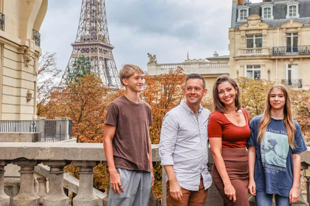 travel resources author Ashley Lauren in Europe with her family in front of the Eiffel Tower
