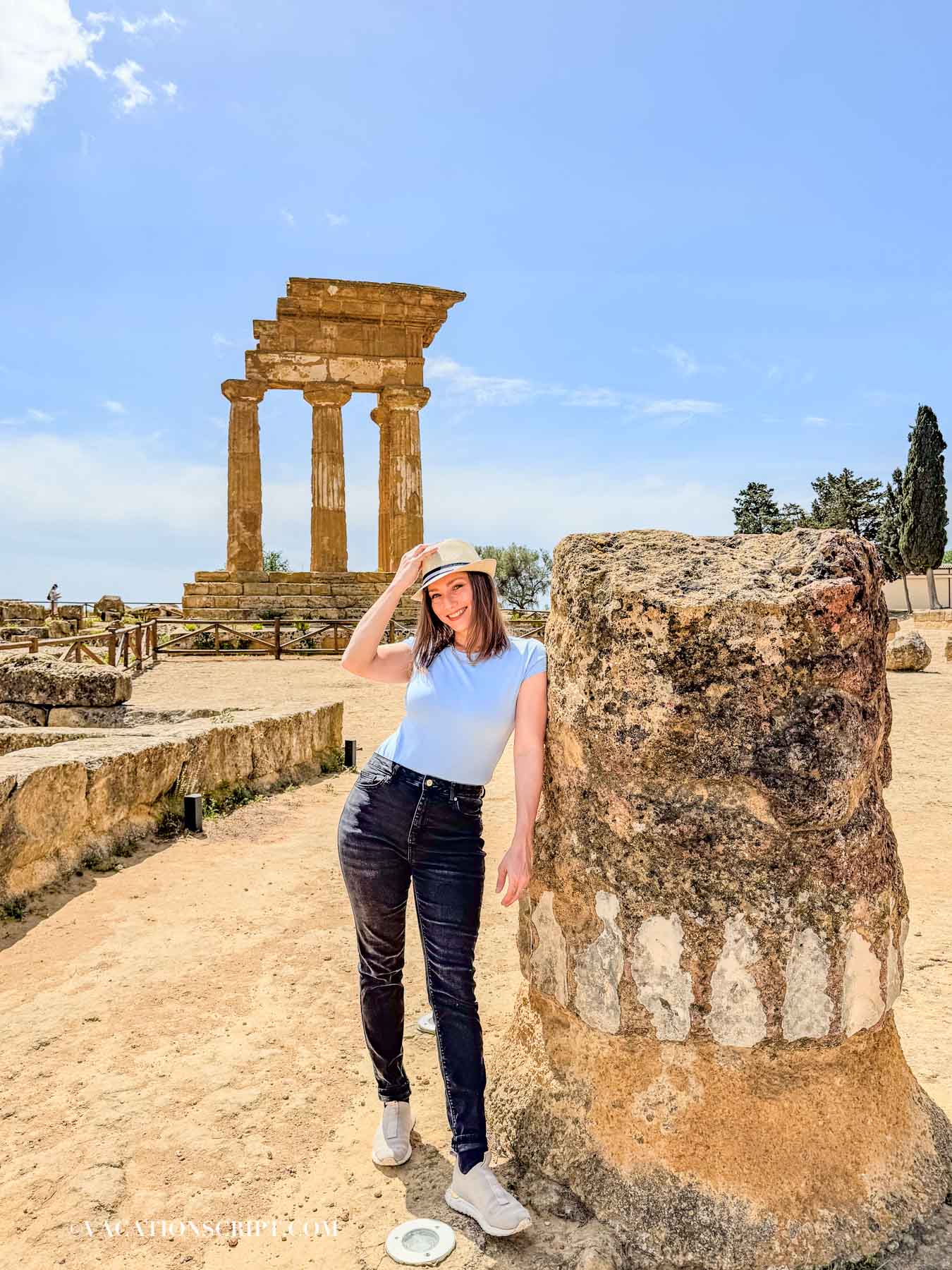 Temple of the Dioscuri with the author leaning against a boulder posing